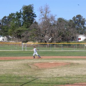 young baseball player playing shortstop, ready to throw the ball across the diamond