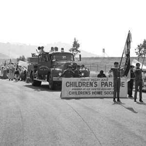 Entrants in the 1972 Conejo Valley Days Children's Parade line up near car dealership. News Chronicle Collection, 05-15-1972_3a_3.  CTO_172.Were happy to share this digital image on Flickr. Please note that this is a copyrighted image. For information regarding obtaining a reproduction of this image, please contact the Special Collections Librarian of the Thousand Oaks Library at specoll@tolibrary.org.