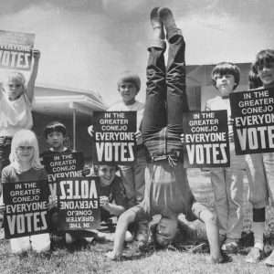 6th graders with get out the vote posters try to get the point across to potential voters are, from left, Nikki Desavia, Emily Bernard, Joey Okuda, Glen Zweifel, Shawn Hindy, Eddie Ruth, and Angela Taha - and Amanda Sheldahl trying to read the upside down message.  News Chronicle Collection, Photographer Joe Luper.  06-06-1982_4a.  We're happy to share this digital image on Flickr. Please note that this is a copyrighted image. For information regarding obtaining a reproduction of this image, please contact the Special Collections Librarian of the Thousand Oaks Library at specoll@tolibrary.org