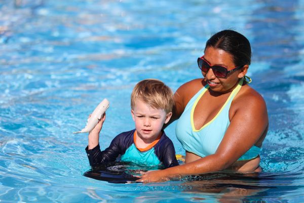 Swim instructor with young child in Seals class
